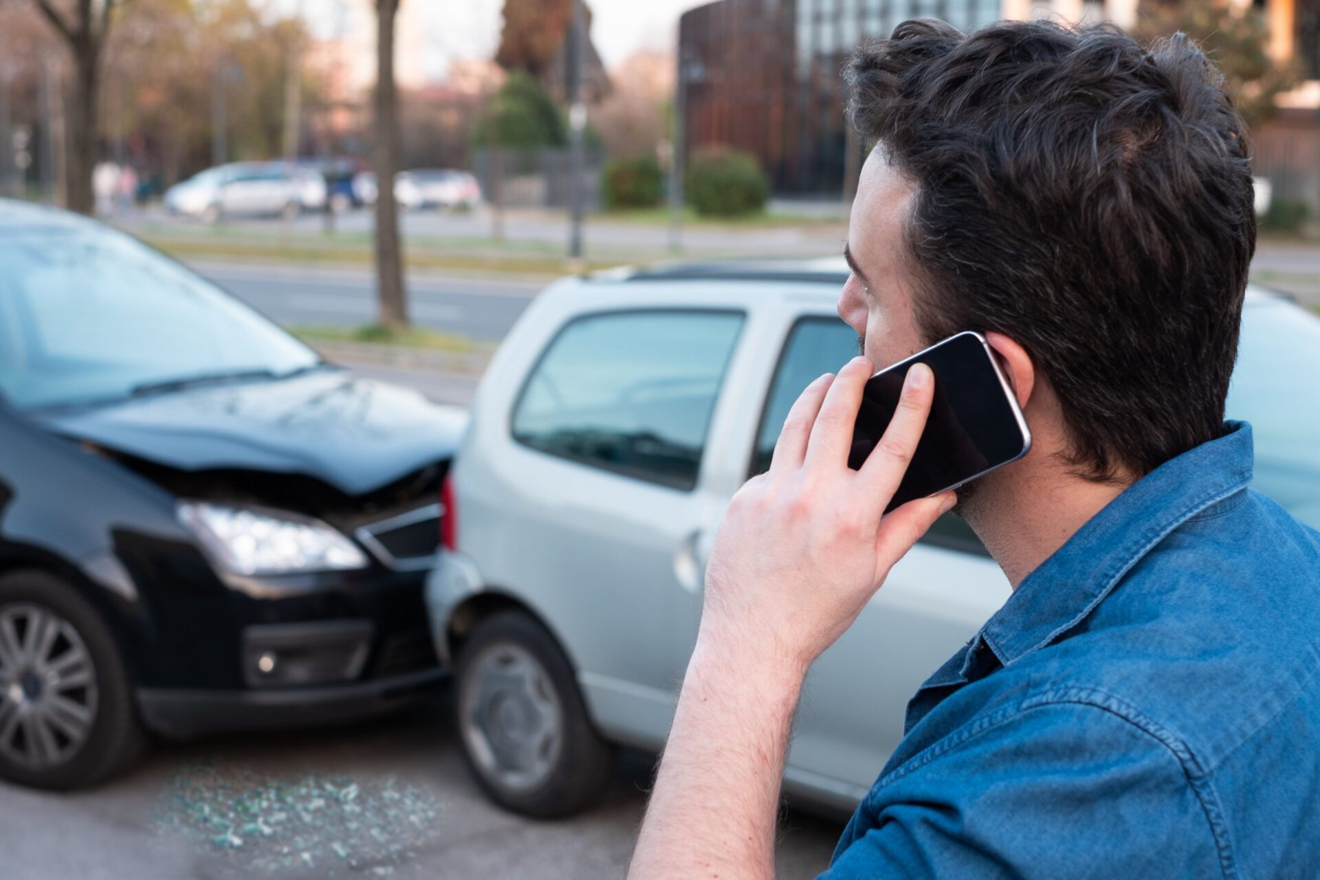 Man calling roadside emergency after car accident Man calling roadside service after car crash